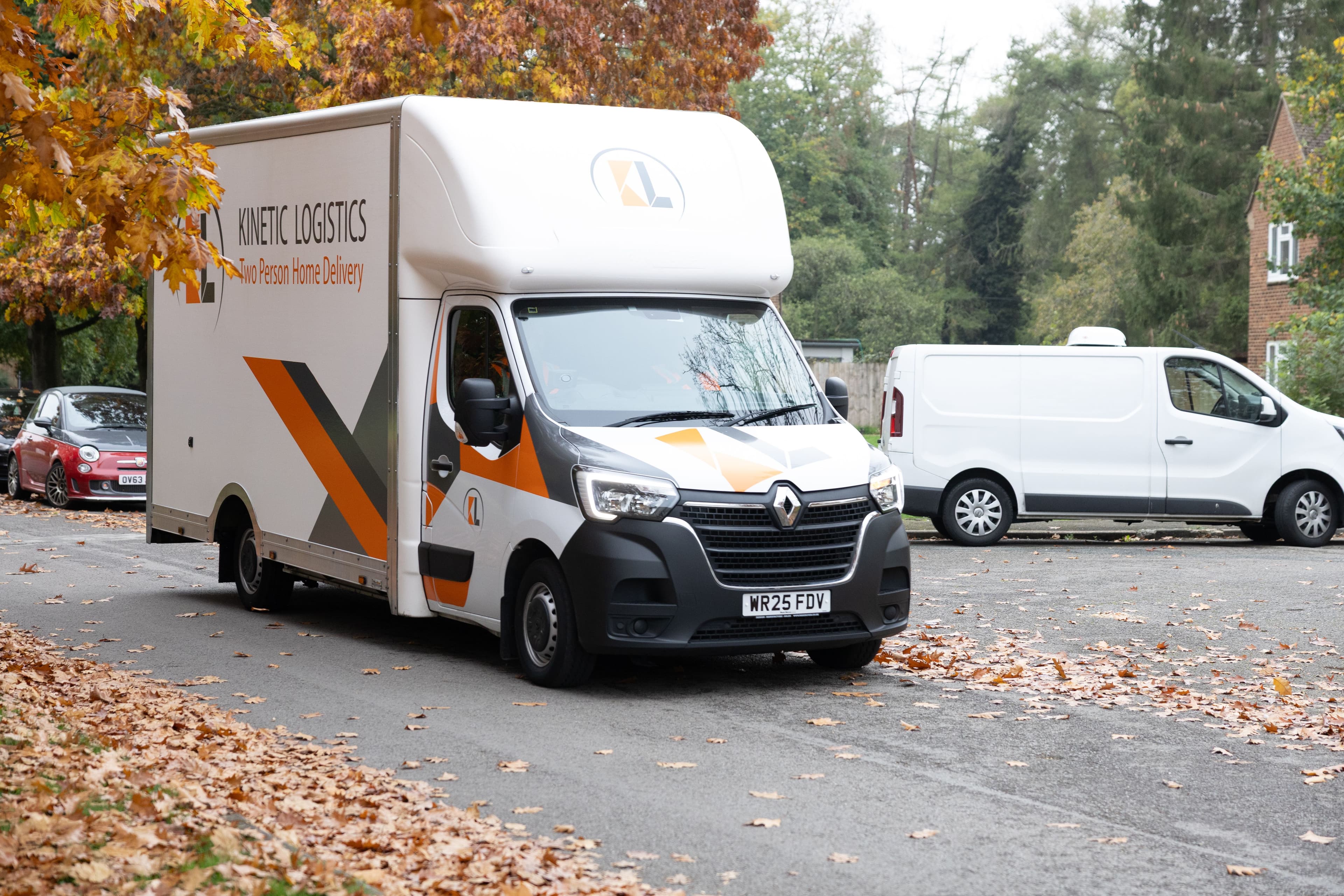 Kinetic Logistics van parked under autumn leaves